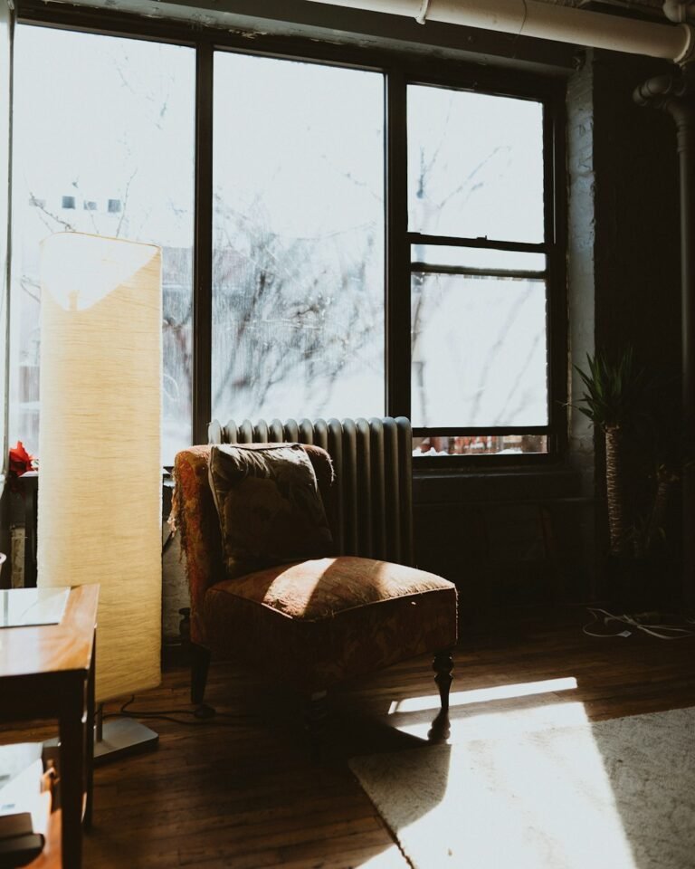 Corner reading nook armchair near window in a small apartment