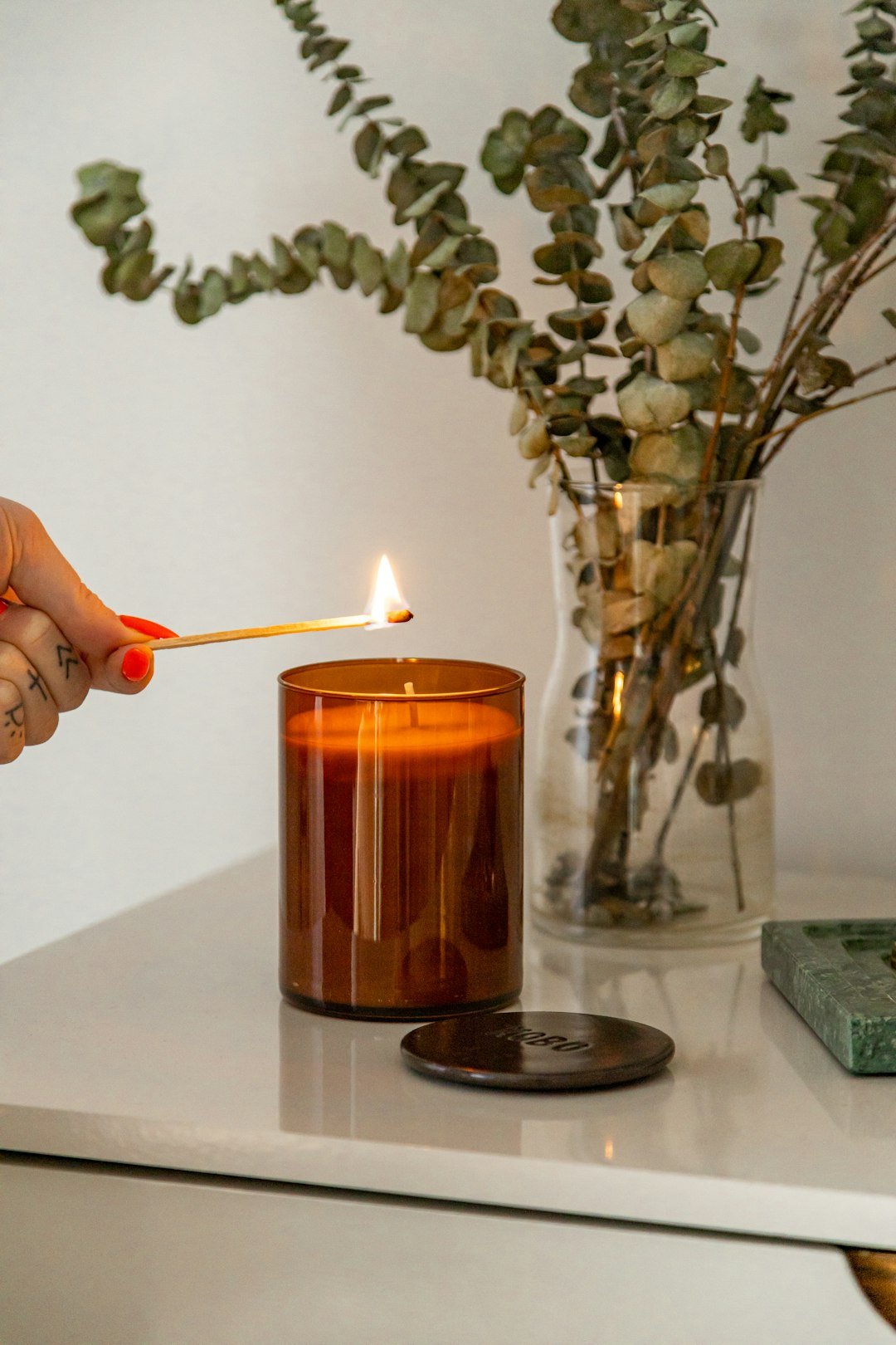 Lighting a candle for warm cozy atmosphere