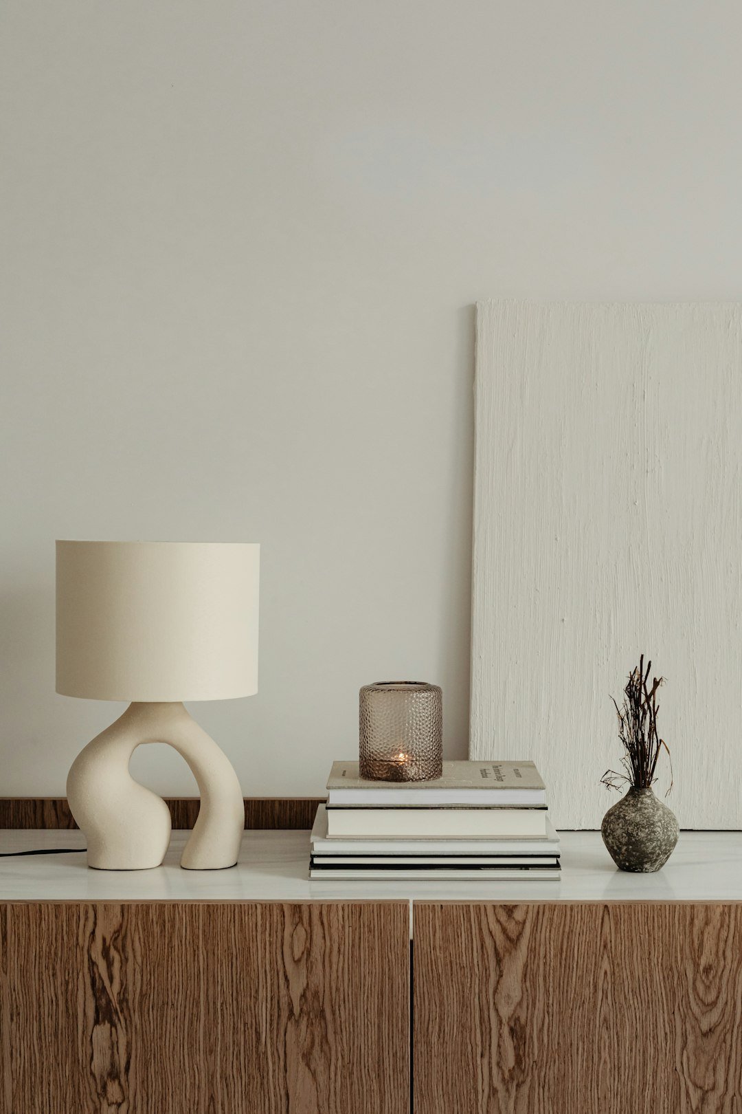 Minimal bedside table with a small lamp