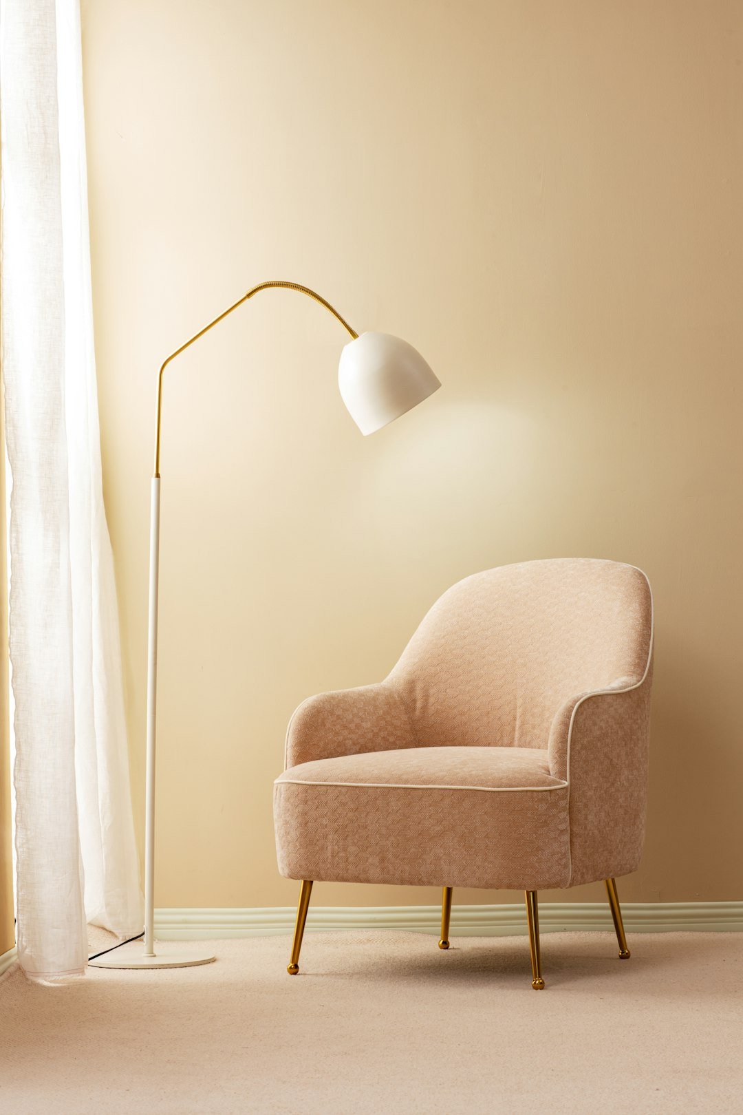 Reading floor lamp with warm light beside a chair