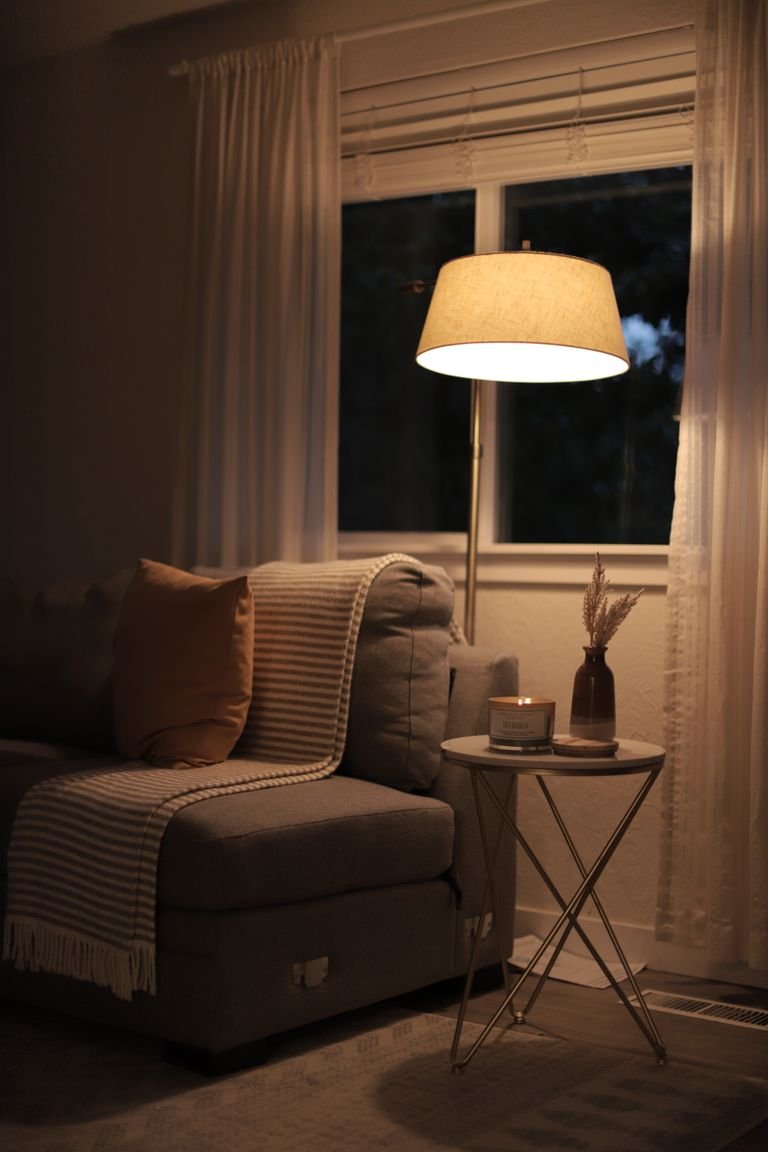 A warm, inviting living room with soft lighting, a comfy sofa, and stylish decor.