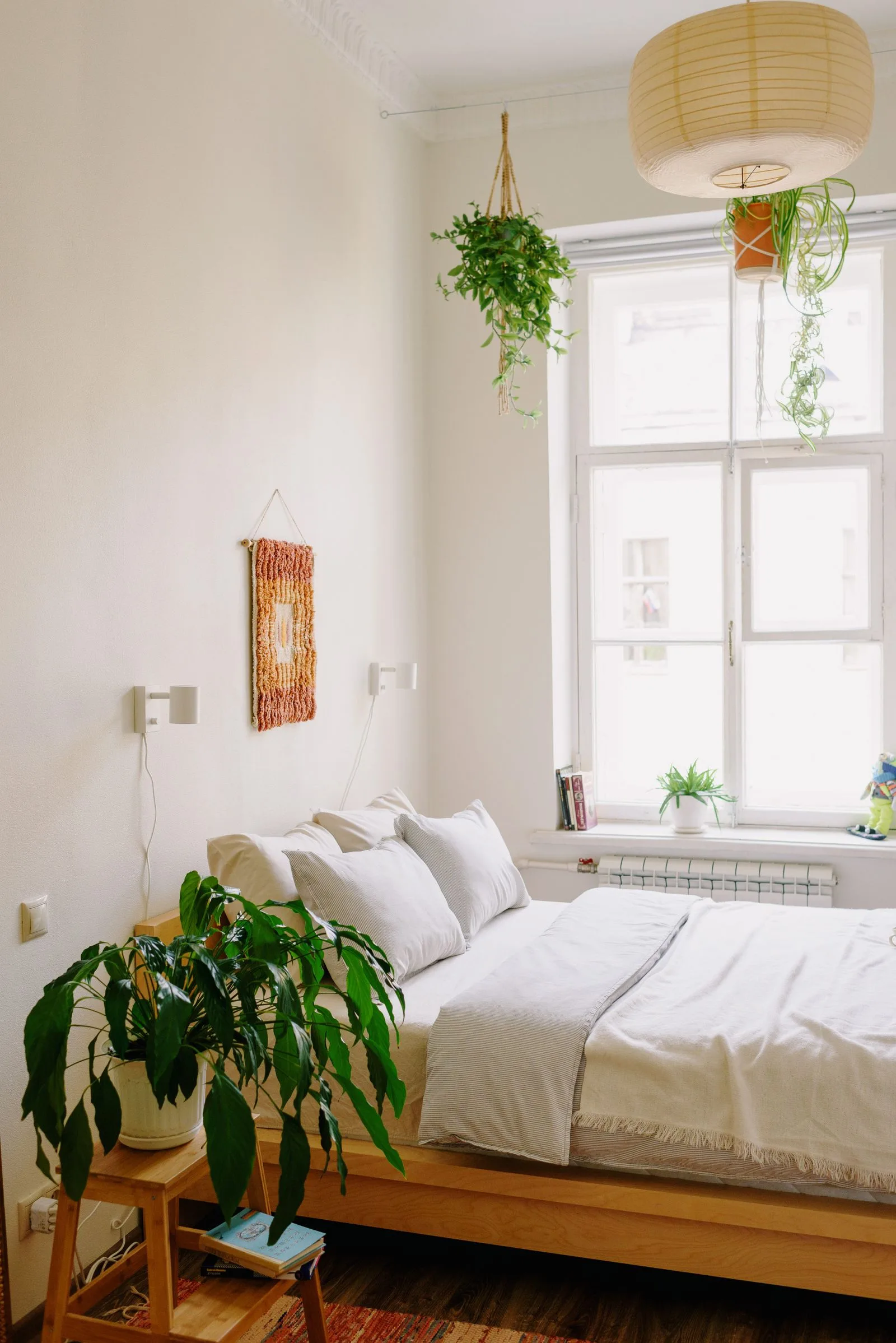 Bright cozy small bedroom with plants and white bedding — aesthetic room decor for small spaces