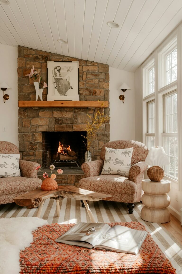 Cozy living room with stone fireplace and comfortable chairs