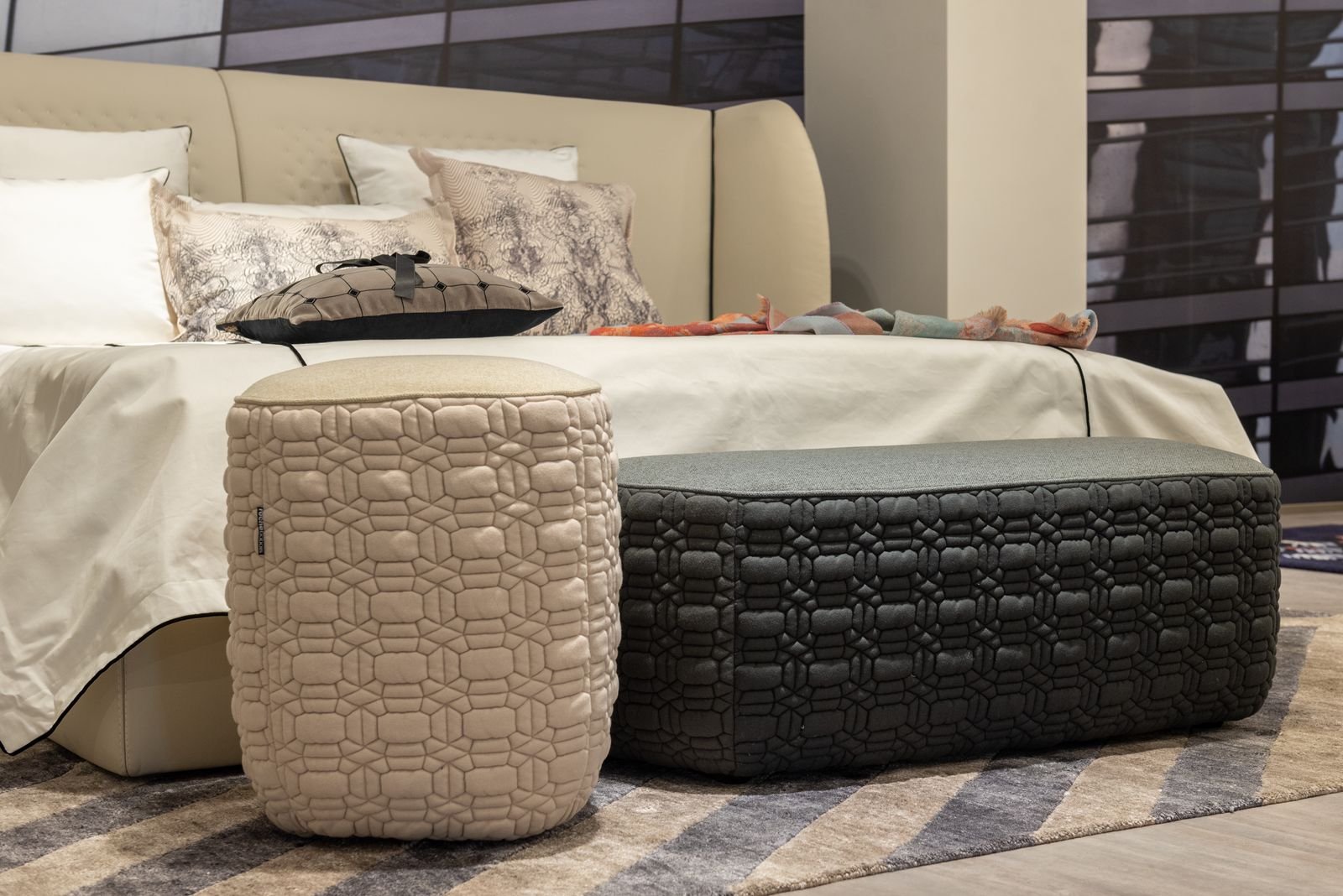 Sofa with cushions and an ottoman on a striped carpet — storage ottoman as extra seat