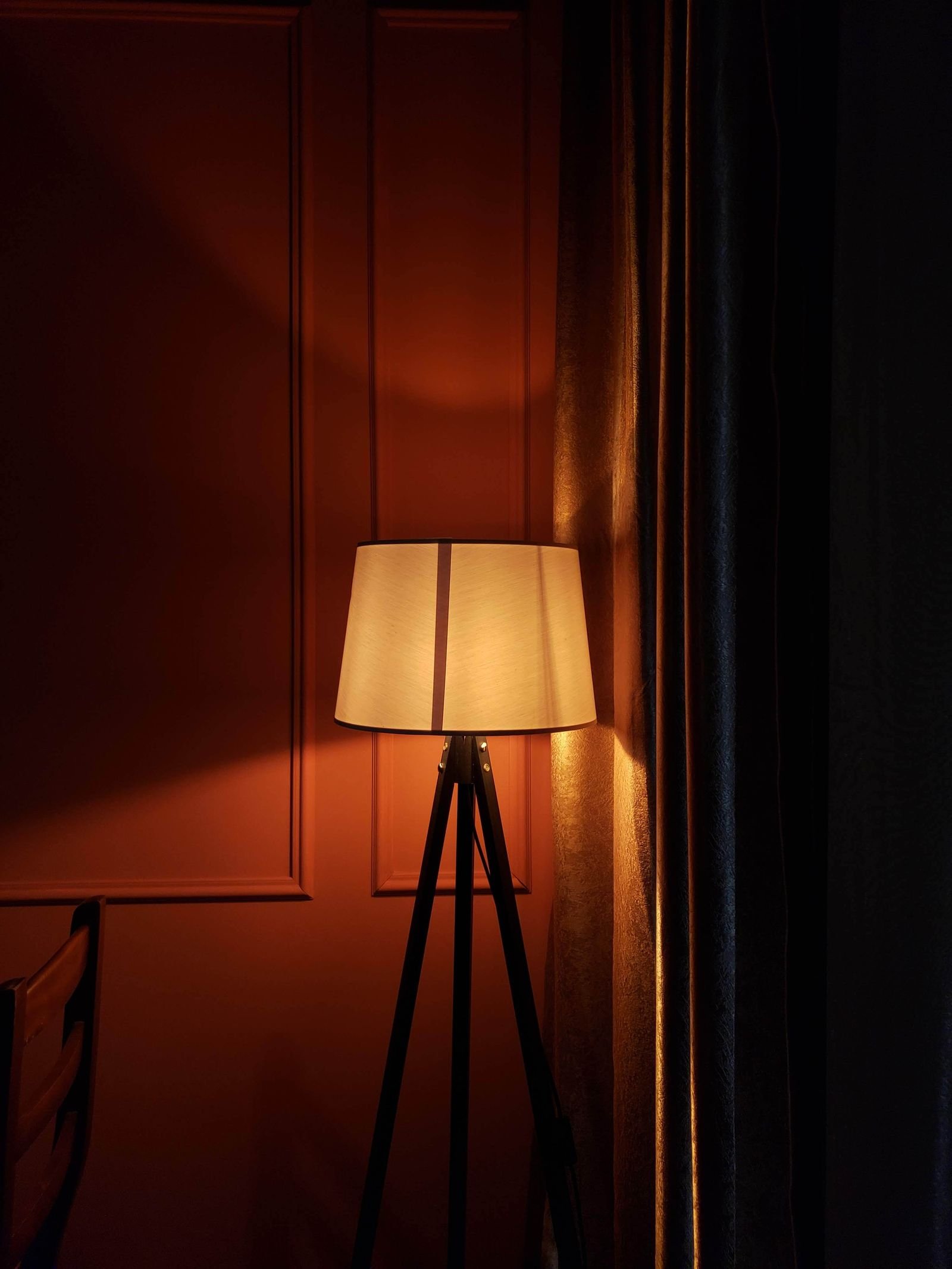Warmly lit floor lamp glowing in a cozy elegant room