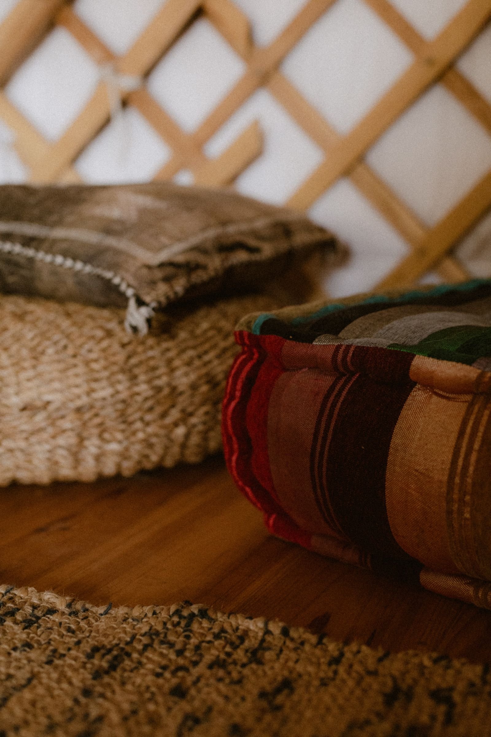 Soft floor cushions on a wooden floor in a cozy space — floor cushions for guests