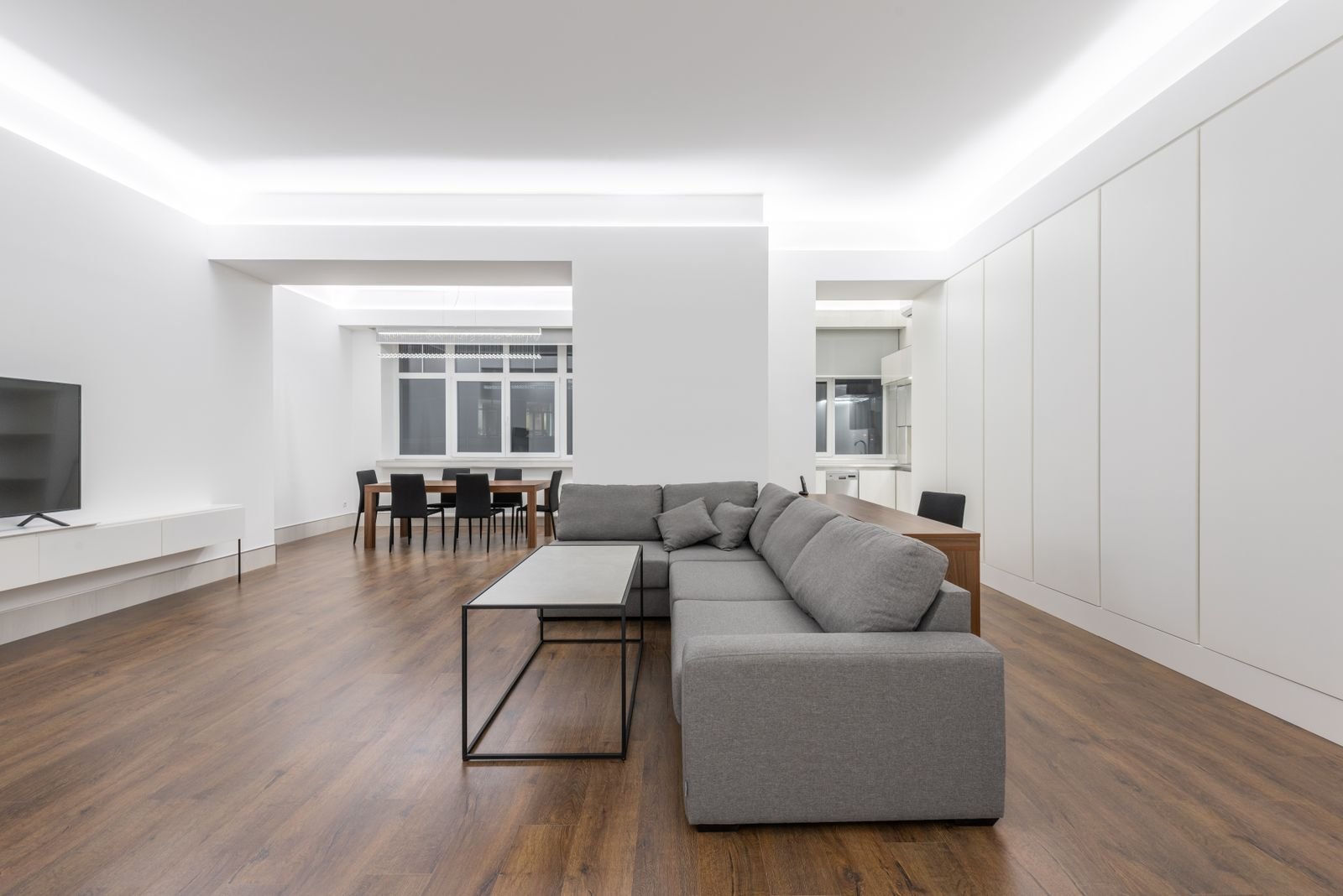 Tidy open living room with a grey sofa and clear walkway