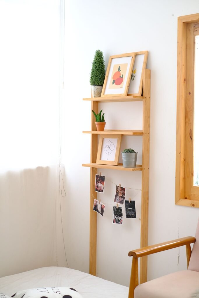 Minimalist wooden wall shelf styled simply in a bright living room — vertical storage ideas