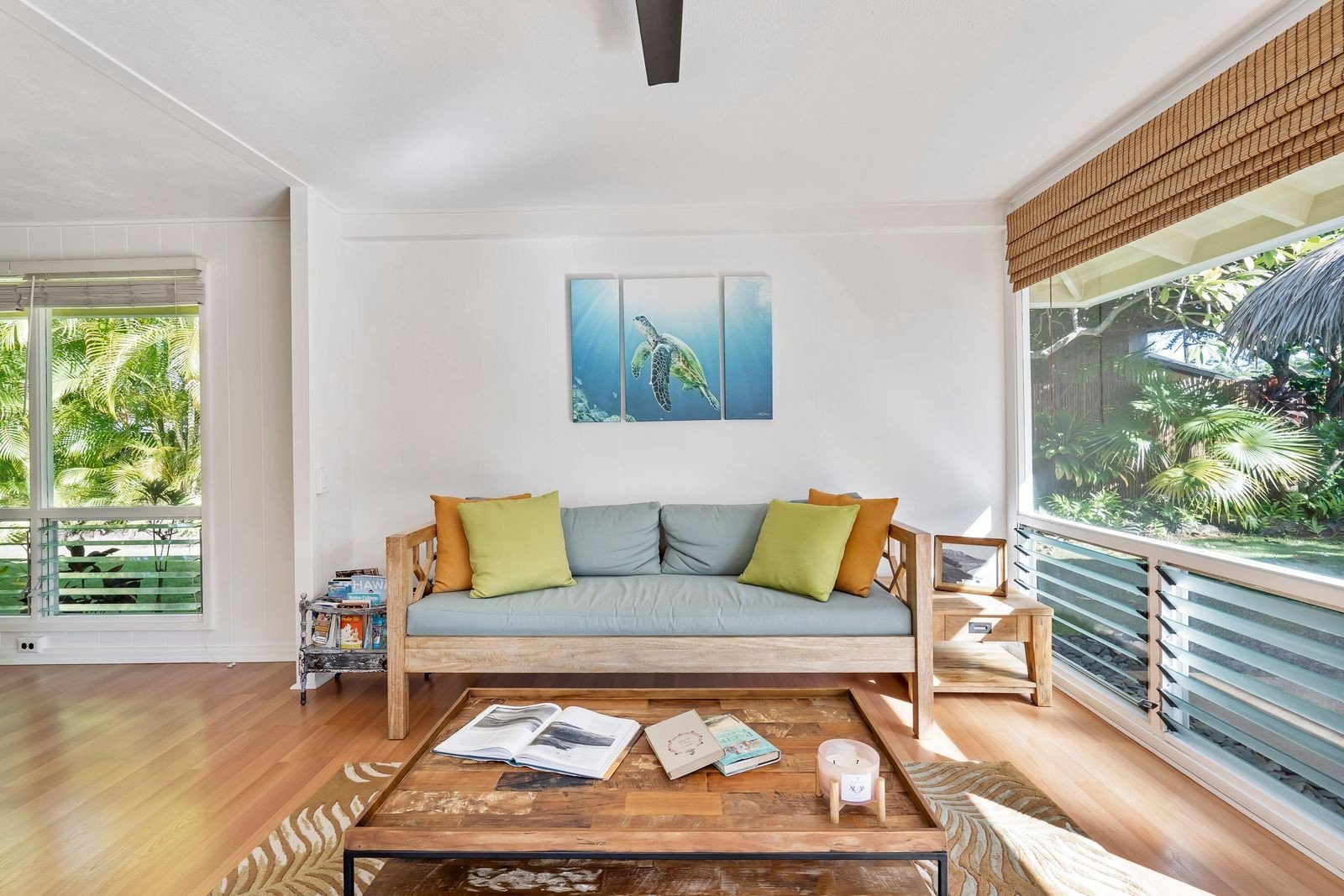 Stylish living room bathed in natural daylight with a view of greenery — a calm, uncluttered small space