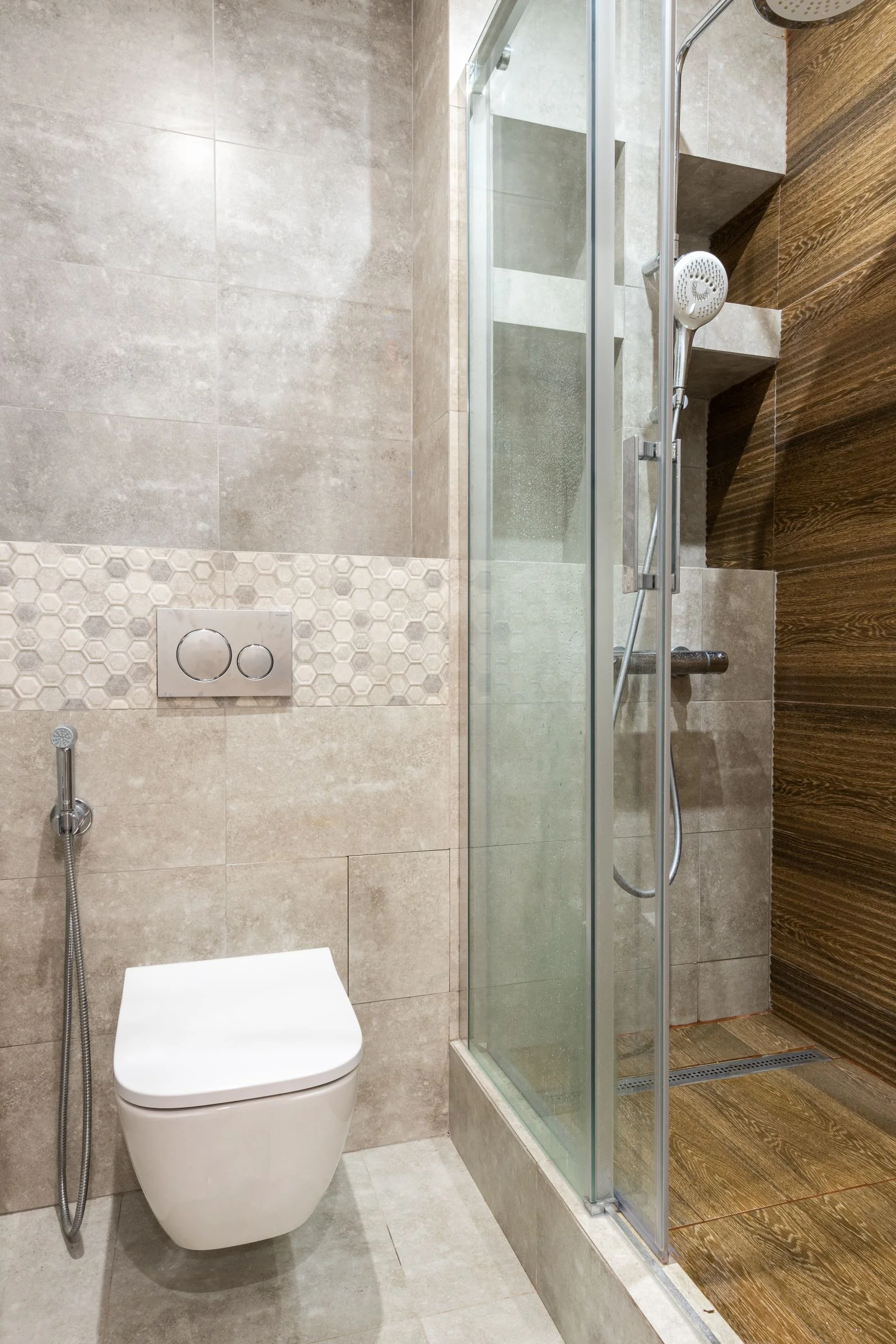 Sleek modern bathroom with a shower stall and wall-mounted toilet — a clear minimal small bathroom shower
