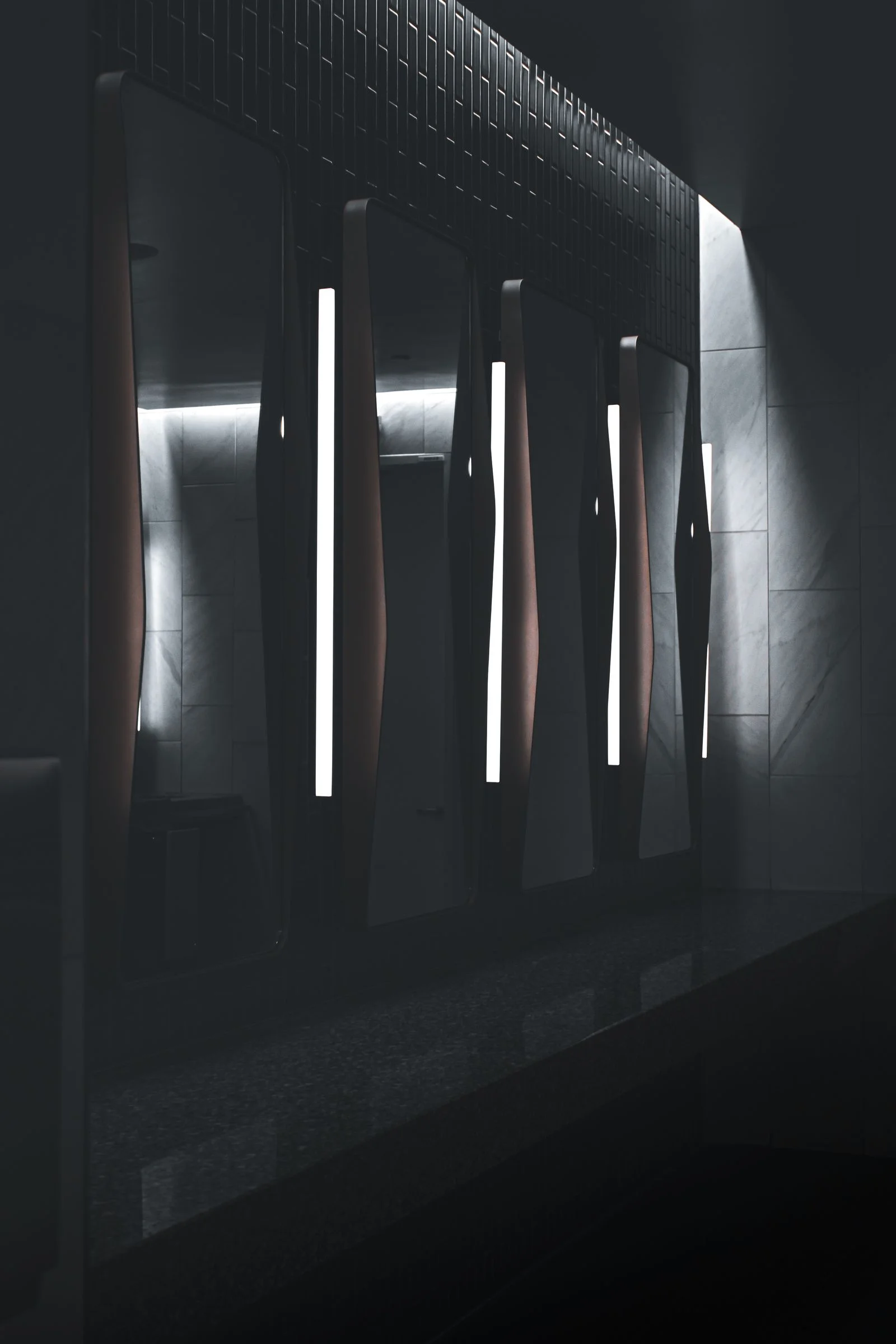 Elegant wall lamp casting warm light against a two-tone wall, minimalist decor style — 3. clip-on or wall sconces save nightstand space