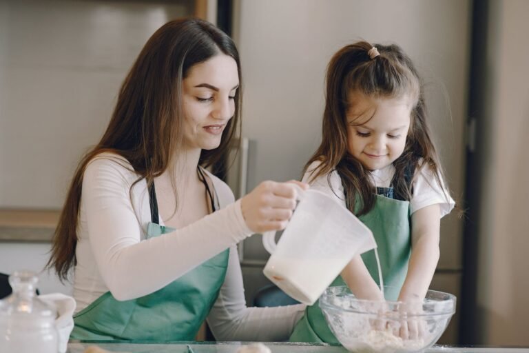 Parent and child cooking together in a small cozy kitchen — small kitchen ideas for cooking with kids safely