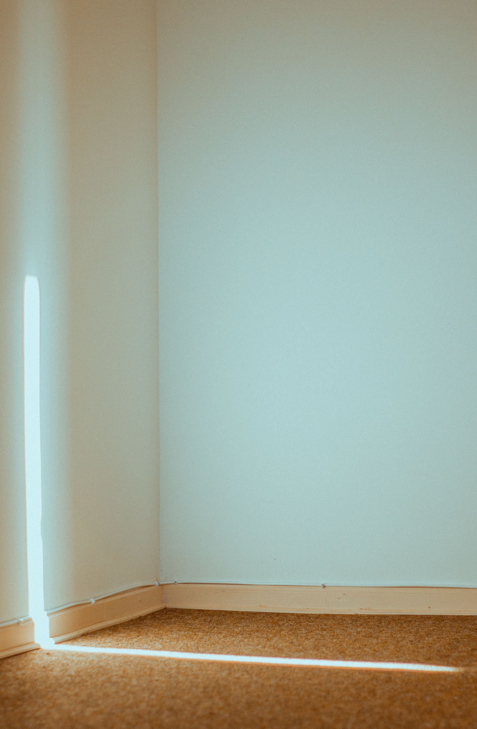 Sunlit empty corner of a room with a beam of sunlight
