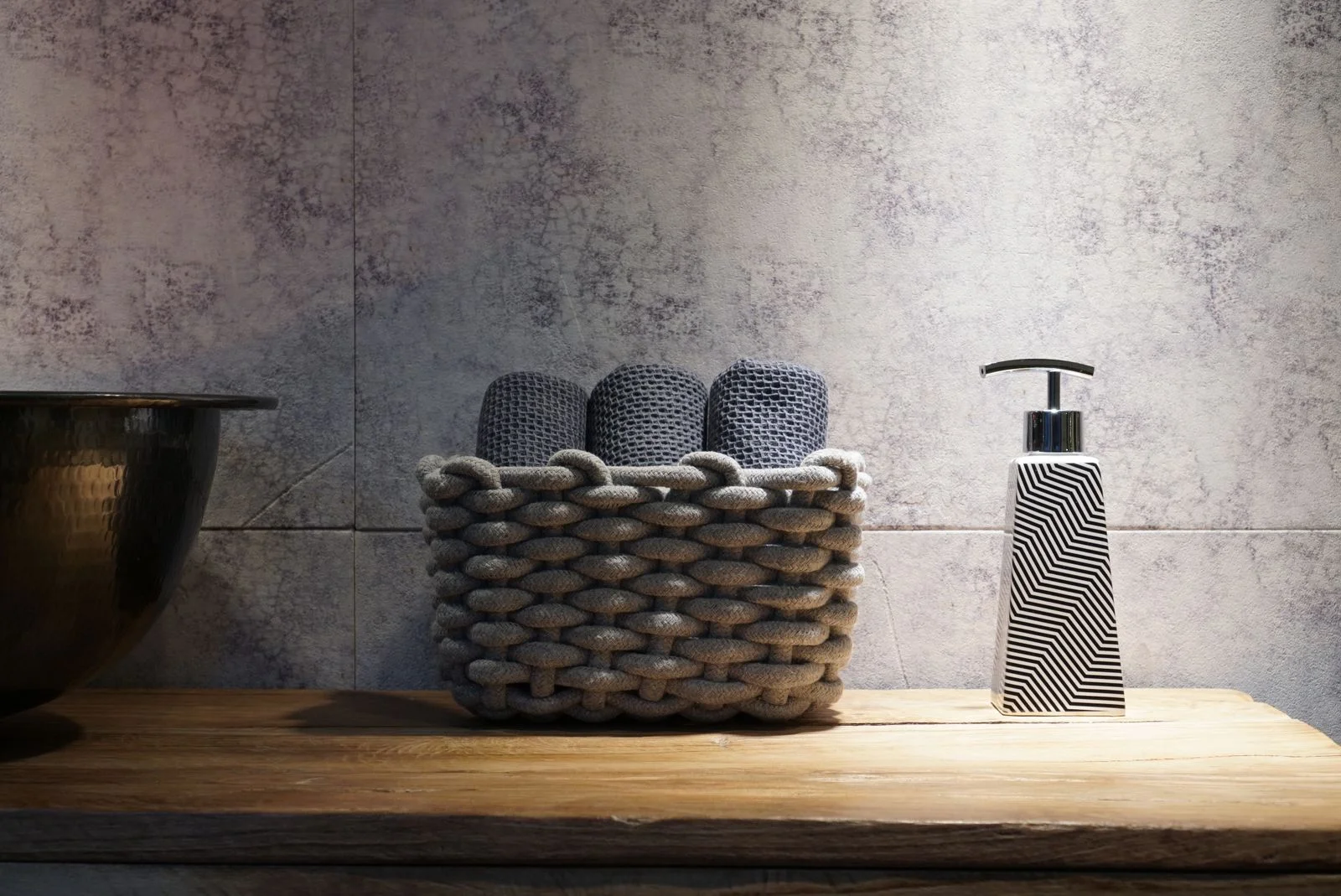 Cozy laundry setup with a woven basket and striped cloth indoors — 2. two laundry baskets, not one mountain