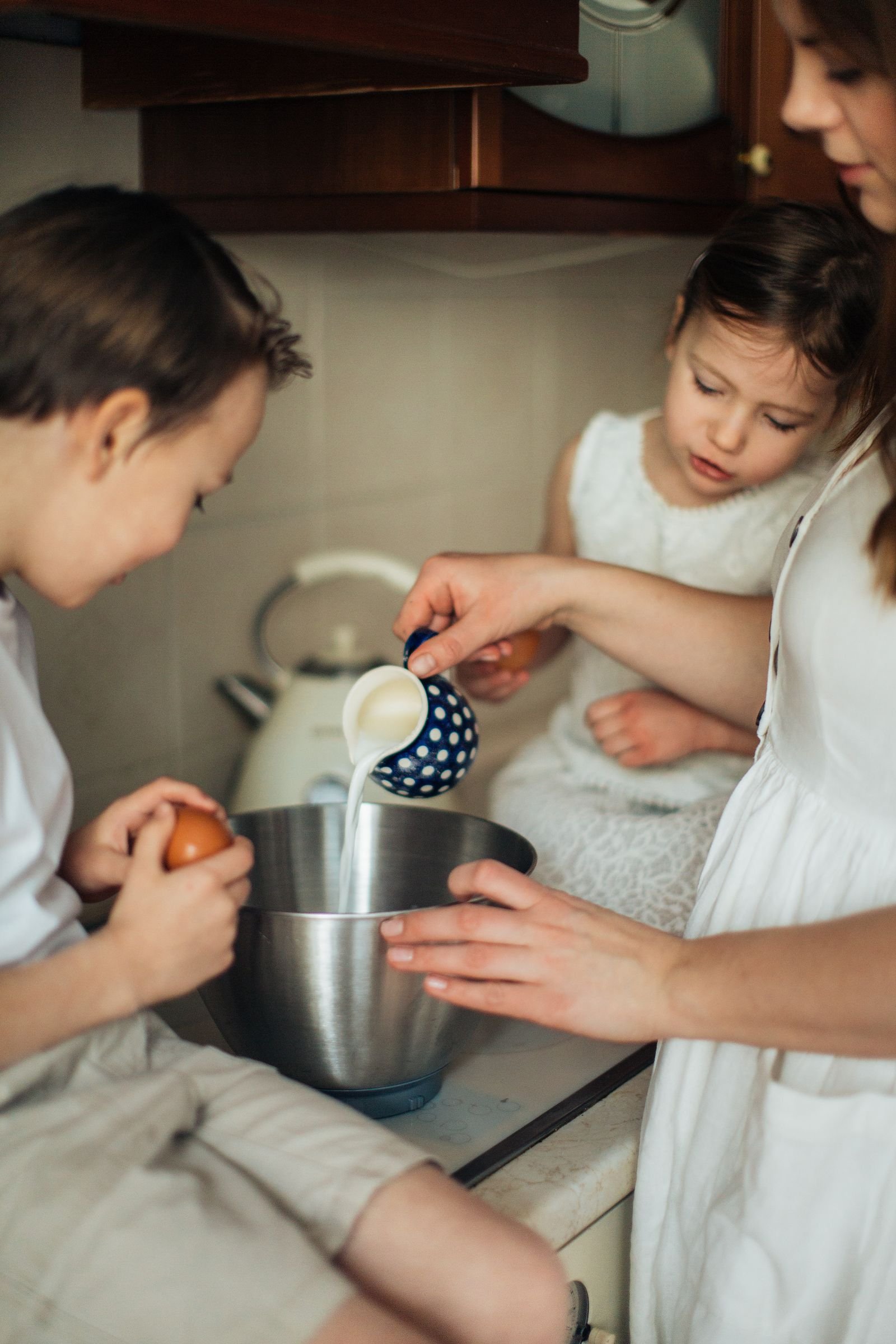 Child using a kid-safe nylon knife to cut soft fruit — cooking with kids safely