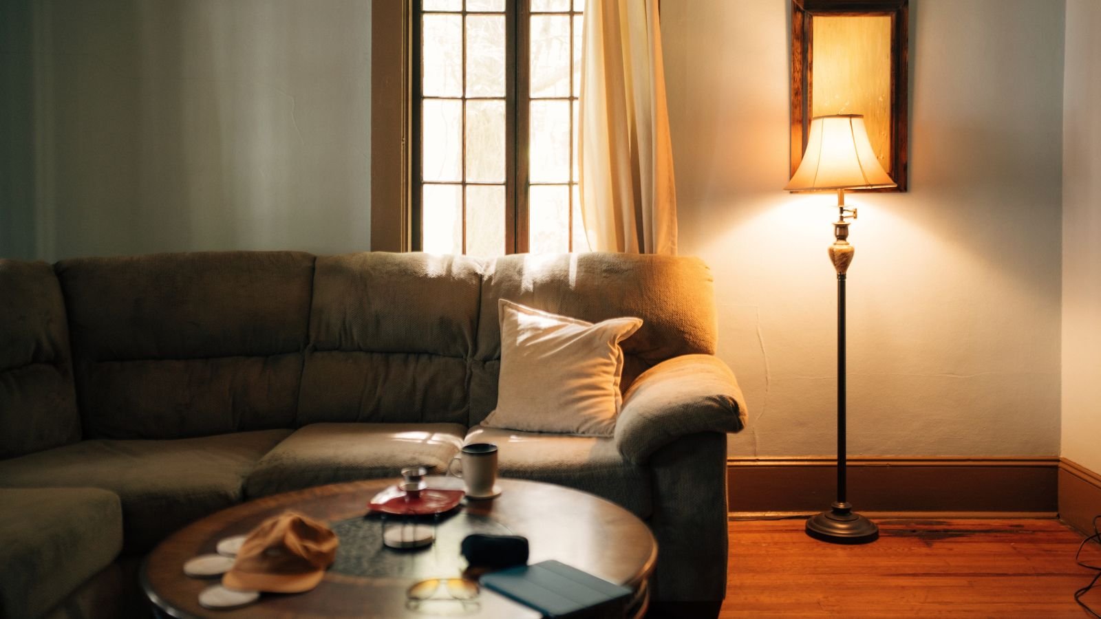 Cozy living room corner lit by a glowing floor lamp