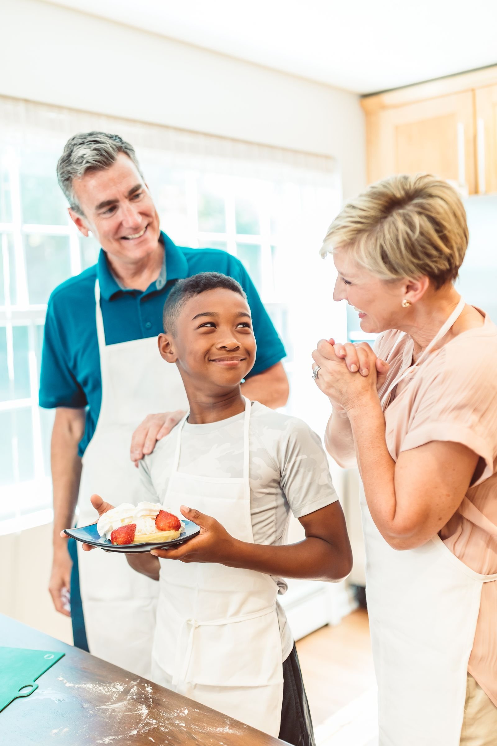 Child sprinkling cheese over a dish — kid-safe cooking jobs in a small kitchen